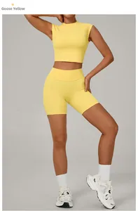 Detail of yellow yoga set featuring high-waisted shorts and a slim sleeveless crop top