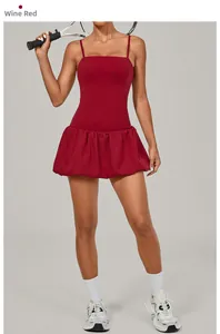 Detail of wine red golf tennis dress featuring thin straps and a pleated bubble hemline