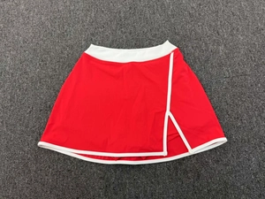 Vue détaillée de la jupe de tennis rouge avec bordure contrastée et fente latérale