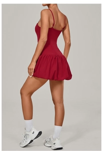 Detail view of red backless golf tennis dress with pleated bubble hem and sporty cutout