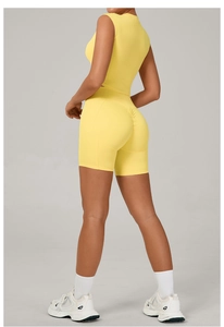 Detail view of yellow yoga set showing high waist scrunch butt shorts and slim fit tank top