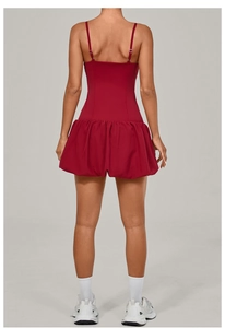 Detail view of wine red mini dress with delicate straps and a ruffle bubble hem design