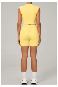Detail of yellow yoga set showing high-waisted shorts with scrunch butt lifting design