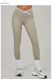 Close-up of linen yoga leggings featuring a unique crossover V-waist and white contrast piping
