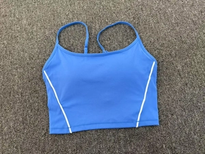 Detail of blue yoga crop top featuring contrast white trim and slim adjustable straps