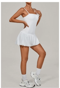 Side view of white pleated tennis dress with thin straps and breathable athletic fabric