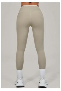 Rear view detail of high-waisted beige yoga leggings highlighting ergonomic back seams