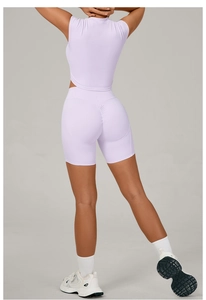 Rear view of lilac yoga set featuring a stand collar top and scrunch butt gym shorts