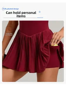 Detail of burgundy pleated tennis dress featuring functional side pocket and built-in liner