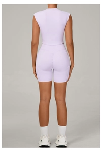 Rear view of lavender two-piece yoga set featuring high-waisted lifting shorts and crop top