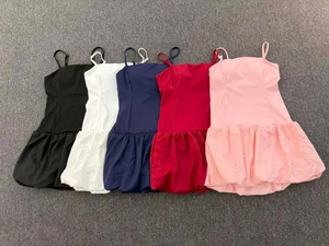 Flat lay of sleeveless pleated tennis dresses in five colors with functional built-in shorts