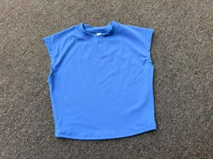 Detailed close-up of blue slim-fit yoga top featuring a mock neck and breathable knit fabric