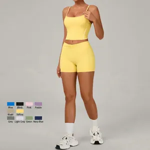 Bright yellow yoga set with thin strap tank top and high waist sports shorts for women