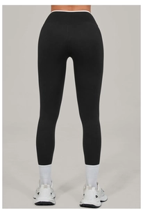 Rear view of black high-waisted yoga leggings with white contrast waistline detail