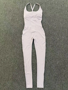 Detailed view of pink yoga bodysuit with thin adjustable straps and vertical stitching lines