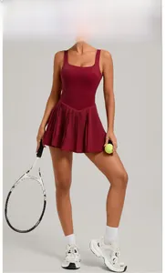 Detail of wine red tennis dress featuring pleated skirt and wide square neck straps