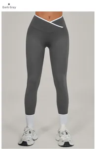 Detail of dark grey yoga leggings with white piping and high waist cross V-cut waistband