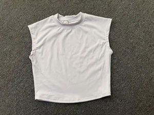 Flat lay detail of a light purple quick-dry yoga top with a high neckline and wide shoulders