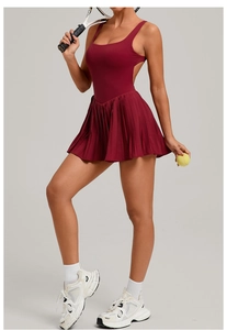 Detail of burgundy backless tennis dress with pleated skirt and athletic racerback design