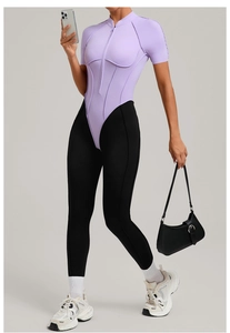 Detail view of contrast stitching and partial zipper on lilac fitness bodysuit