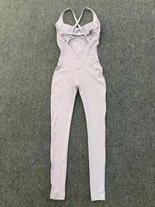 Detail view of the criss-cross back straps and V-shaped waist design on the yoga bodysuit