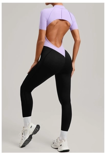 Detail view of contrast stitching yoga jumpsuit featuring an open back and half-zip collar