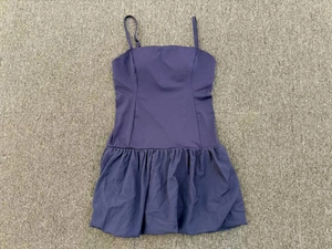 Detail view of purple golf dress featuring thin adjustable straps and ruffled skirt textures