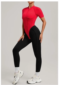 Red stand-collar zipper top paired with black leggings showing athletic fit and fabric
