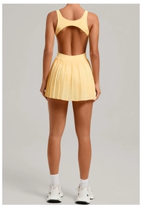 Detail view of the open back design and pleated hem on a yellow sports dress
