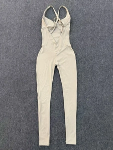 Detail showing high-stretch quick-dry beige yoga jumpsuit with crisscross back straps