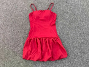 Detailed view of red sleeveless bubble hem dress with adjustable straps and sleek texture