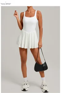 Detailed view of an ivory white tennis dress with pleated skirt and backless design