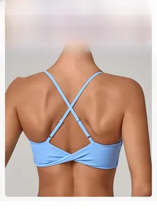 Detail showing the criss-cross thin straps and twist knot design of the sky blue sports bra