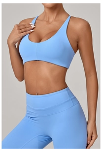 Detail view of sky blue high-stretch yoga bra and high-waist leggings on model