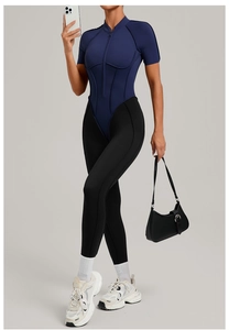 Mirror selfie showing sport bodysuit with stand collar and sleek contrast stitching details