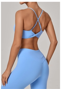 Detail of cross-back twist design on sky blue sports bra and high-waist yoga leggings