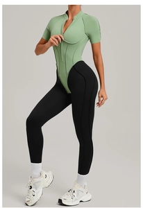 Detail view of mint green stand collar sports bodysuit and high waist black yoga leggings