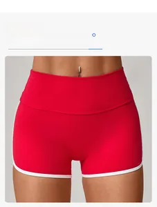 Detail showing high-waisted design with contrast white piping on red athletic shorts
