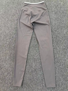 Detailed view of high waisted dark gray yoga leggings with white inner contrast waistband