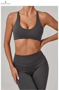 Detail of graphite grey back-twist sports bra and high waist yoga leggings on model