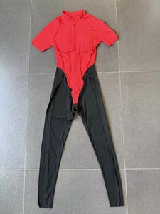 Flat lay of red and black color-block athletic bodysuit with high neck and front zipper
