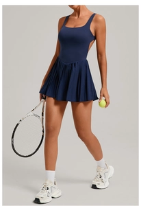 Detail of navy blue backless tennis dress with pleated hem and sleeveless athletic design