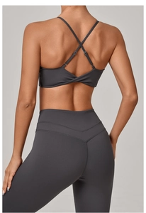 Detail of cross-back yoga bra and high-waist leggings with twisted knot design