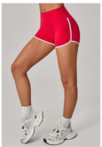 Detail showing red yoga shorts with white piping trim and high waist stitching