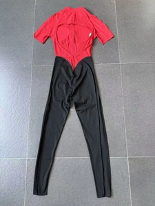 Flat lay view of a red and black color block athletic bodysuit with back cutout detail