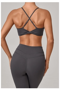 Close-up of charcoal yoga set with criss-cross back bra and V-seam high waist leggings