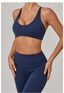 Detail view of navy blue yoga set showing the cross back sports bra and high waist leggings