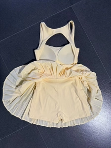 Detail view of backless tennis dress with pleated skirt, built-in pads and safety shorts