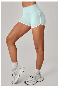 Detail view of high-waist light blue yoga shorts with white edges and high elasticity fabric