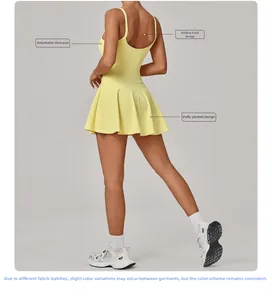 Detail view of yellow athletic dress showing cutout back design and pleated hemline